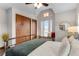 Bright bedroom features a window seat, complemented by decorative closets and natural light at 402 Roosevelt St, Palmer Lake, CO 80133