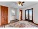 Bedroom with wood floors, ceiling fan, a large rug, and a balcony with scenic mountain views at 402 Roosevelt St, Palmer Lake, CO 80133