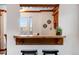 Bright breakfast bar features a wooden countertop and a stylish opening to an adjacent living space at 402 Roosevelt St, Palmer Lake, CO 80133