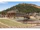 Modern pedestrian bridge with metal framework, offering scenic views of the surrounding landscape at 402 Roosevelt St, Palmer Lake, CO 80133