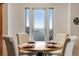 Bright dining area featuring large windows with blinds, providing an abundance of natural light at 402 Roosevelt St, Palmer Lake, CO 80133
