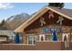 Quaint stone building with gingerbread Personal decorations and blue awnings at 402 Roosevelt St, Palmer Lake, CO 80133