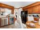 Kitchen area with stainless fridge, oak cabinets and dining table at 402 Roosevelt St, Palmer Lake, CO 80133
