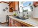 Kitchen sink with butcher block countertop, with a view from a window to the outside at 402 Roosevelt St, Palmer Lake, CO 80133