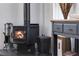 Cozy living room featuring a wood-burning stove and decorative accents at 402 Roosevelt St, Palmer Lake, CO 80133