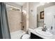 Bright bathroom featuring a shower-tub combo and a sleek vanity with sink at 6173 Eldora St, Golden, CO 80403