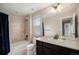 Cozy bathroom featuring a shower-tub combo and modern vanity with sink at 6173 Eldora St, Golden, CO 80403
