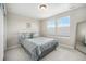 Bright bedroom with two windows, plush carpeting, and a comfortable bed at 6173 Eldora St, Golden, CO 80403