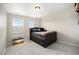 Bedroom with a wooden bed with drawers, gray carpet, and two windows with pleated shades at 6173 Eldora St, Golden, CO 80403