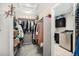 Walk-in closet leading to a laundry room with modern washer and dryer at 6173 Eldora St, Golden, CO 80403