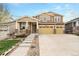 Inviting two-story home with a three car garage, covered porch, and well-maintained front yard at 6173 Eldora St, Golden, CO 80403