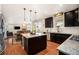 Open-concept kitchen with a center island, stainless steel appliances, and hardwood floors at 6173 Eldora St, Golden, CO 80403