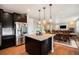 Well-appointed kitchen featuring a central island, stainless steel fridge, and ample counter space at 6173 Eldora St, Golden, CO 80403