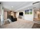 Spacious basement living room featuring a fireplace, comfortable seating, and access to the bar at 6173 Eldora St, Golden, CO 80403