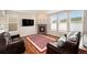 Comfortable living room with hardwood floors, fireplace, and large windows at 6173 Eldora St, Golden, CO 80403