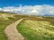 Scenic walking path with grassy hillsides offers a serene and picturesque escape at 6173 Eldora St, Golden, CO 80403