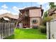 Spacious backyard offers ample green space, wooden fence, playset, shed, and access to a private balcony at 1430 Monroe St, Denver, CO 80206
