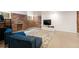 Basement with comfortable armchairs, a brick fireplace, and a large screen TV at 1430 Monroe St, Denver, CO 80206