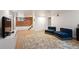 Finished basement area features exposed brick and comfortable seating at 1430 Monroe St, Denver, CO 80206