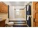 Bathroom with tiled shower and tub, hexagon floor tiles, and bright window at 1430 Monroe St, Denver, CO 80206