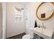 Bright bathroom featuring subway tile, black floors, and updated fixtures at 1430 Monroe St, Denver, CO 80206