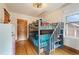 Cozy bedroom with a gray bunk bed, wood floors, and plenty of natural light at 1430 Monroe St, Denver, CO 80206
