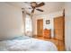Bright bedroom featuring hardwood floors, a ceiling fan, and multiple windows at 1430 Monroe St, Denver, CO 80206