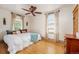 Spacious bedroom with hardwood floors, ceiling fan, and bright windows at 1430 Monroe St, Denver, CO 80206