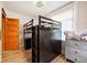 Bedroom featuring a lofted bed, wood floors, and a gray dresser at 1430 Monroe St, Denver, CO 80206