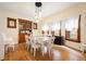 Bright dining room with a white table, hardwood floors, and vintage built-in cabinet at 1430 Monroe St, Denver, CO 80206