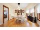 Spacious dining room with hardwood floors, a white table, and vintage built-in cabinet at 1430 Monroe St, Denver, CO 80206