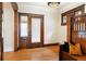 Elegant foyer with hardwood floors, vintage light fixture, and charming stained-glass window at 1430 Monroe St, Denver, CO 80206