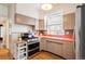 Bright kitchen with stainless appliances, light wood floors and orange countertops at 1430 Monroe St, Denver, CO 80206