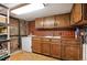 Basement kitchenette with wood cabinets, tile backsplash, and extra freezer space at 1430 Monroe St, Denver, CO 80206