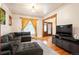 Inviting living room with a plush gray sectional sofa, hardwood floors, and bright natural light at 1430 Monroe St, Denver, CO 80206