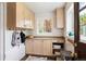 Mud room with wood cabinets and drawers, natural light, and coat hooks at 1430 Monroe St, Denver, CO 80206