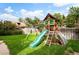 Backyard playground features a slide, swing set, climbing wall, and charming playhouse for outdoor fun at 1430 Monroe St, Denver, CO 80206