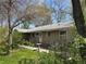 Relax on the backyard patio with a bird bath, surrounded by green grass and mature trees at 1950 Glen Shiel Dr, Lakewood, CO 80215