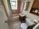 Bathroom with a tub/shower combination, pink tile, and patterned wallpaper at 1950 Glen Shiel Dr, Lakewood, CO 80215