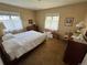 Bedroom with a bed, dresser, and windows with natural light at 1950 Glen Shiel Dr, Lakewood, CO 80215