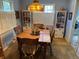 Cozy dining room featuring a wooden table with chairs, built in bookshelves, and unique stained glass lighting fixture at 1950 Glen Shiel Dr, Lakewood, CO 80215