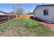 Backyard featuring mature lawn, wooden fence and a sprinkler system at 4793 S Swadley St, Morrison, CO 80465