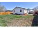 Large backyard featuring grass, a new wooden fence and an irrigation system at 4793 S Swadley St, Morrison, CO 80465
