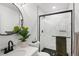 Sleek bathroom featuring a glass-enclosed shower and modern fixtures at 4793 S Swadley St, Morrison, CO 80465
