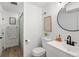 Bright bathroom featuring modern fixtures, a round mirror and a shower with a decorative curtain at 4793 S Swadley St, Morrison, CO 80465