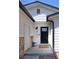 Inviting front entrance with a decorative black door and stone veneer at 4793 S Swadley St, Morrison, CO 80465