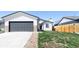 Beautiful exterior showcasing a well-kept lawn, a two-car garage, and stone accents at 4793 S Swadley St, Morrison, CO 80465