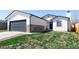 Charming exterior of a home featuring a two-car garage and stone accents at 4793 S Swadley St, Morrison, CO 80465