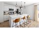 Bright kitchen featuring island seating, modern lighting, and sleek countertops at 4793 S Swadley St, Morrison, CO 80465