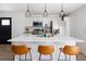 Stylish kitchen with a breakfast bar, modern appliances, and pendant lighting at 4793 S Swadley St, Morrison, CO 80465